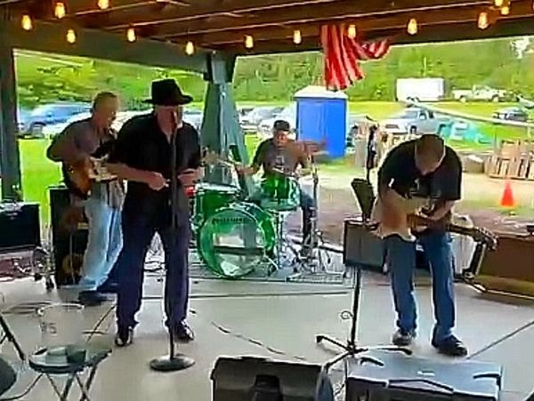 The Fabulous Kings performing live at an outdoor pavilion